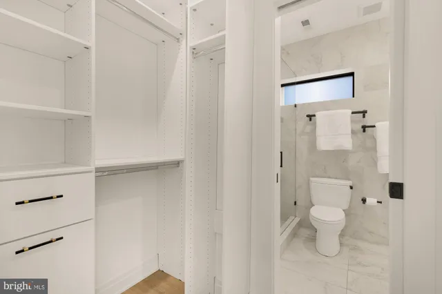 a bathroom with a toilet and a shower