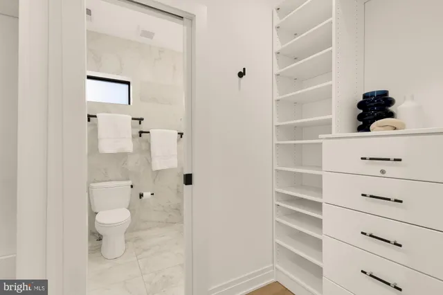 a bathroom with a toilet and a shower