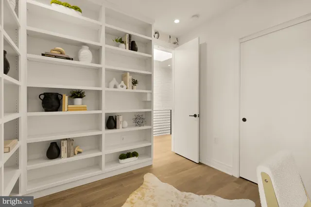 a view of living room with furniture and white cabinets
