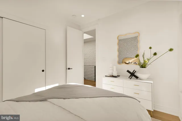 a bedroom with a bed and a mirror