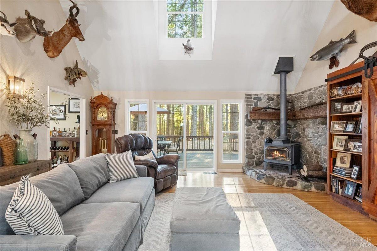 5701 Ridgewood Road Willits, CA 95490 - Photo 28 of 84 a living room with furniture a lamp and a floor to ceiling window