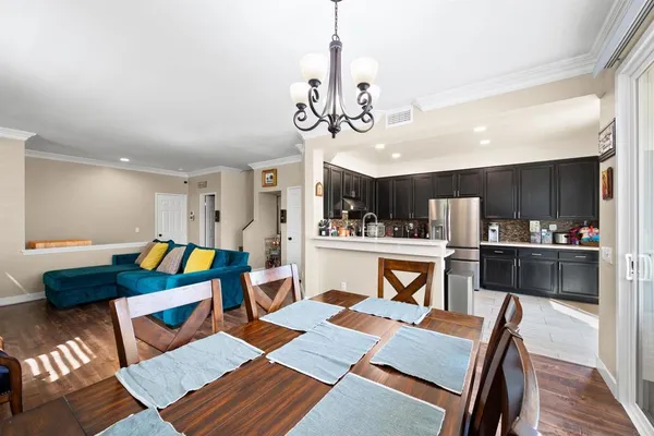 a living room with furniture and kitchen view