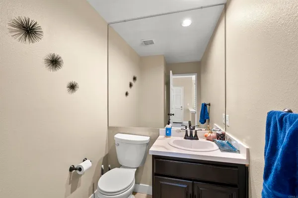 a bathroom with a sink a toilet a mirror and shower