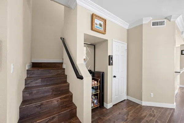 a view of entryway with stairs and wooden floor