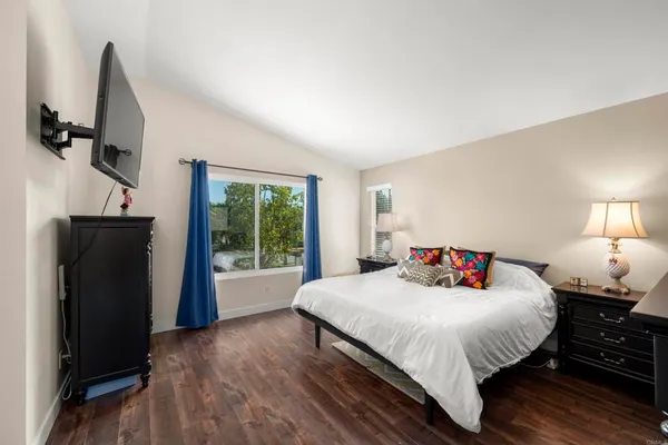 a bedroom with a bed and large window