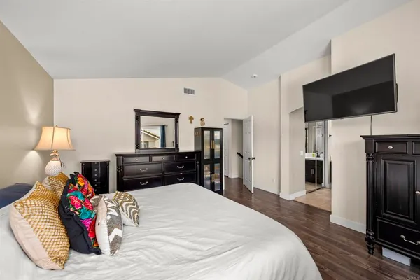 a bedroom with a bed and a flat screen tv
