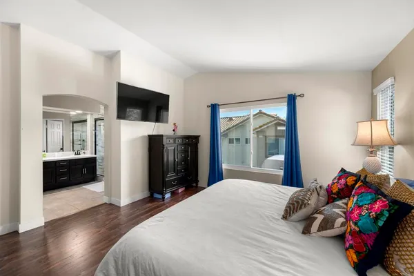 a bedroom with a bed and a flat screen tv