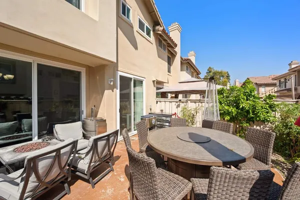 a view of a patio with table and chairs and potted plants