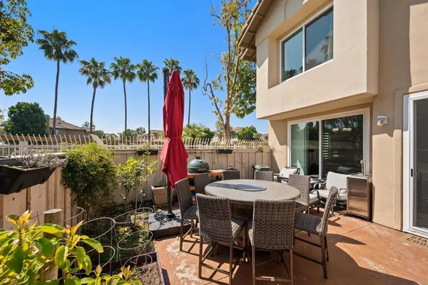 a view of a patio with table and chairs and potted plants