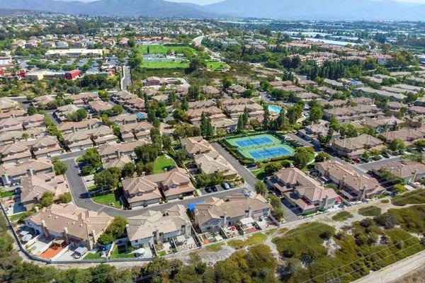 an aerial view of residential houses with outdoor space