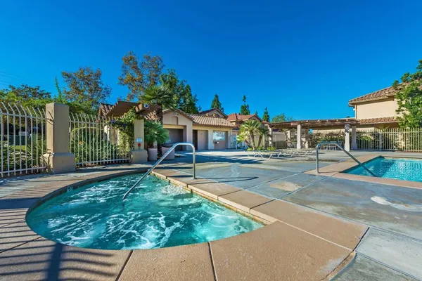 a view of house with swimming pool outdoor seating