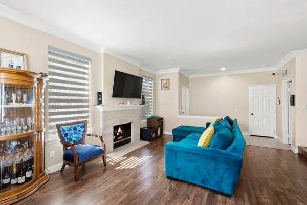 a living room with furniture a fireplace and a flat screen tv