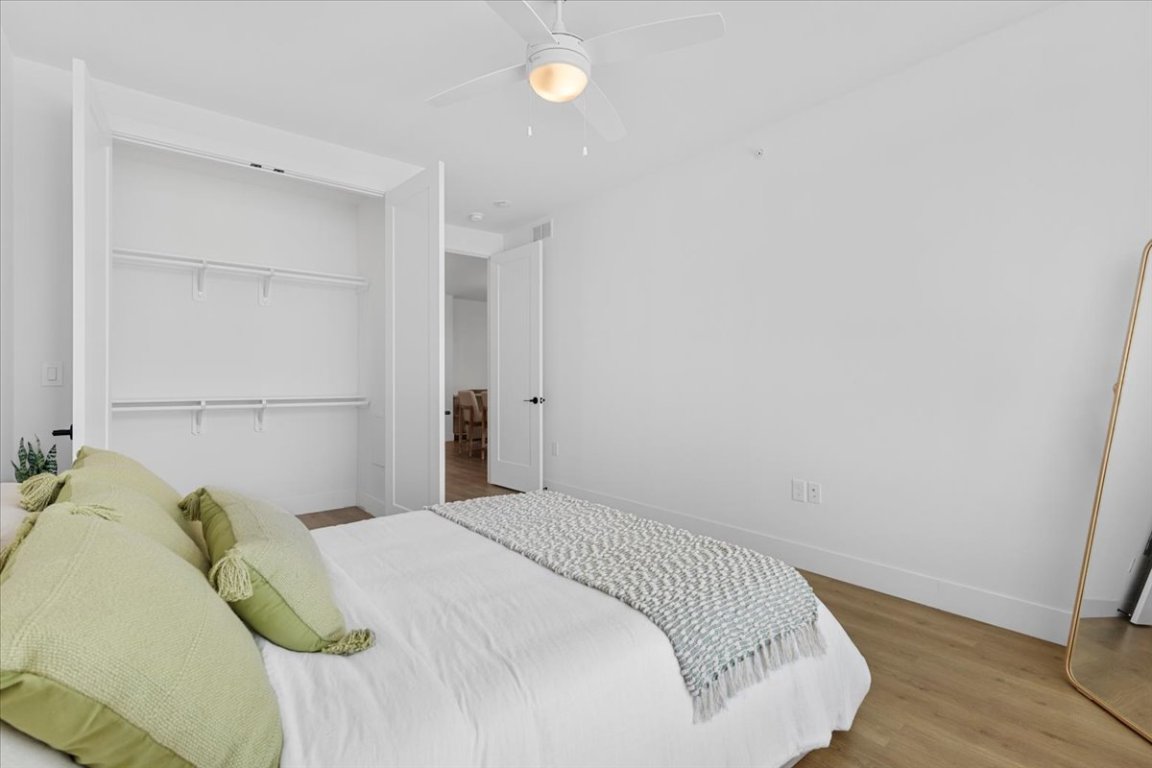 1701 Simond Avenue, Unit 636 Austin, TX 78723 - Photo 12 of 34 a bedroom with a bed and lamp