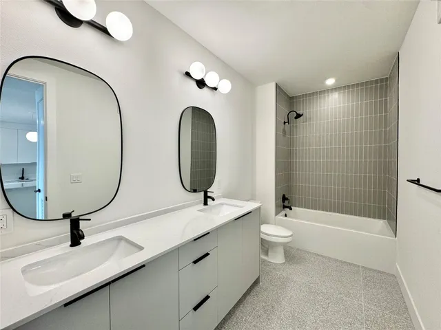 a bathroom with a toilet a sink and a mirror