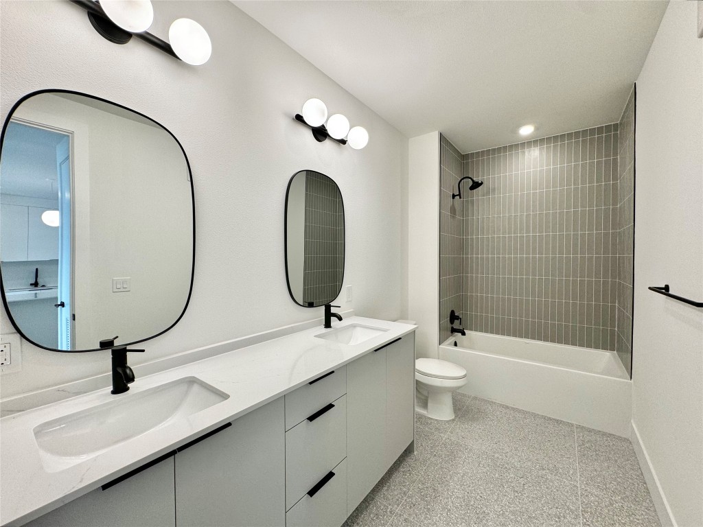 1701 Simond Avenue, Unit 636 Austin, TX 78723 - Photo 13 of 34 a bathroom with a toilet a sink and a mirror