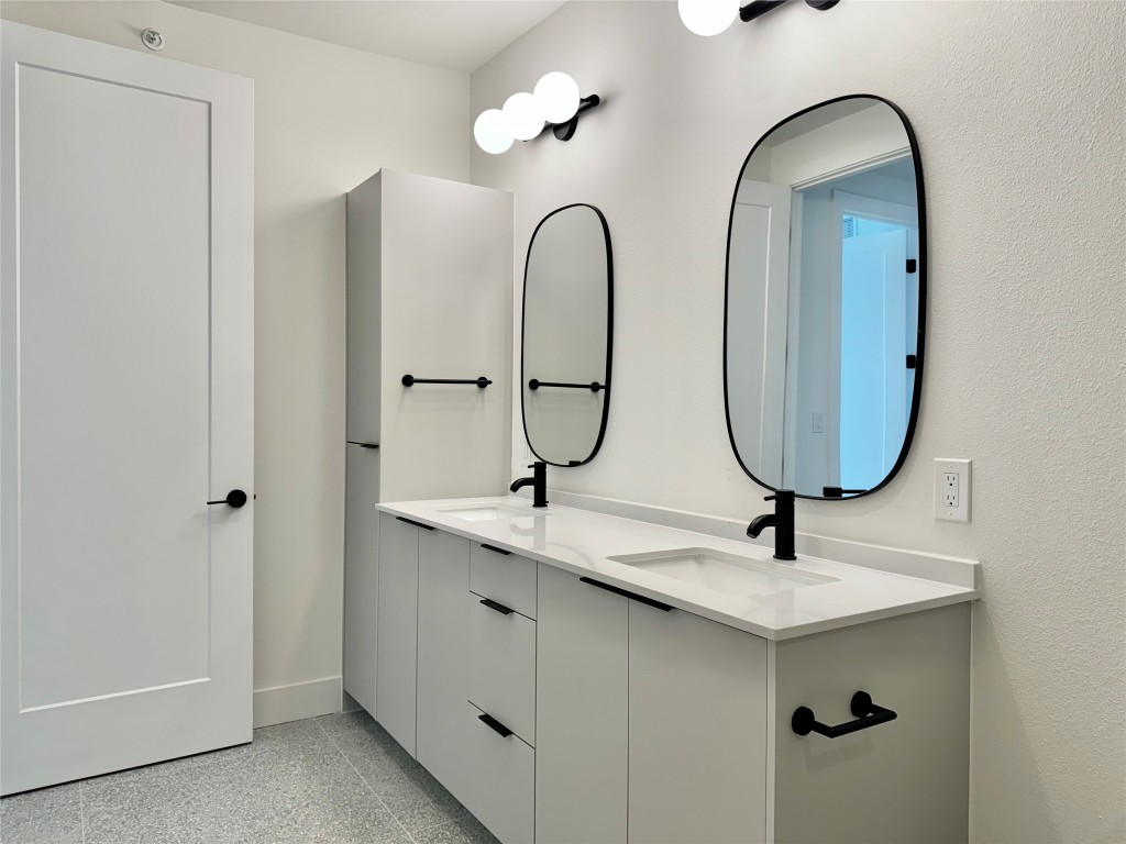 1701 Simond Avenue, Unit 636 Austin, TX 78723 - Photo 14 of 34 a bathroom with a double vanity sink and a mirror