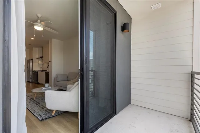 a view of a hallway to a livingroom and a couch
