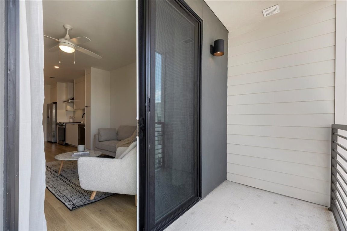 1701 Simond Avenue, Unit 636 Austin, TX 78723 - Photo 18 of 34 a view of a hallway to a livingroom and a couch