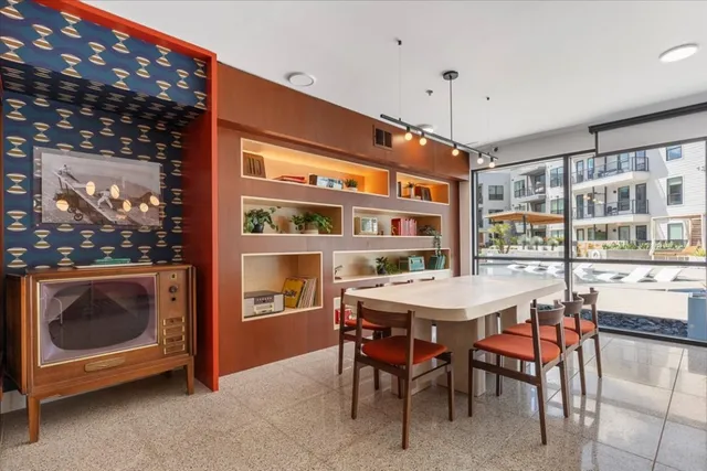 a view of a swimming pool with outdoor seating