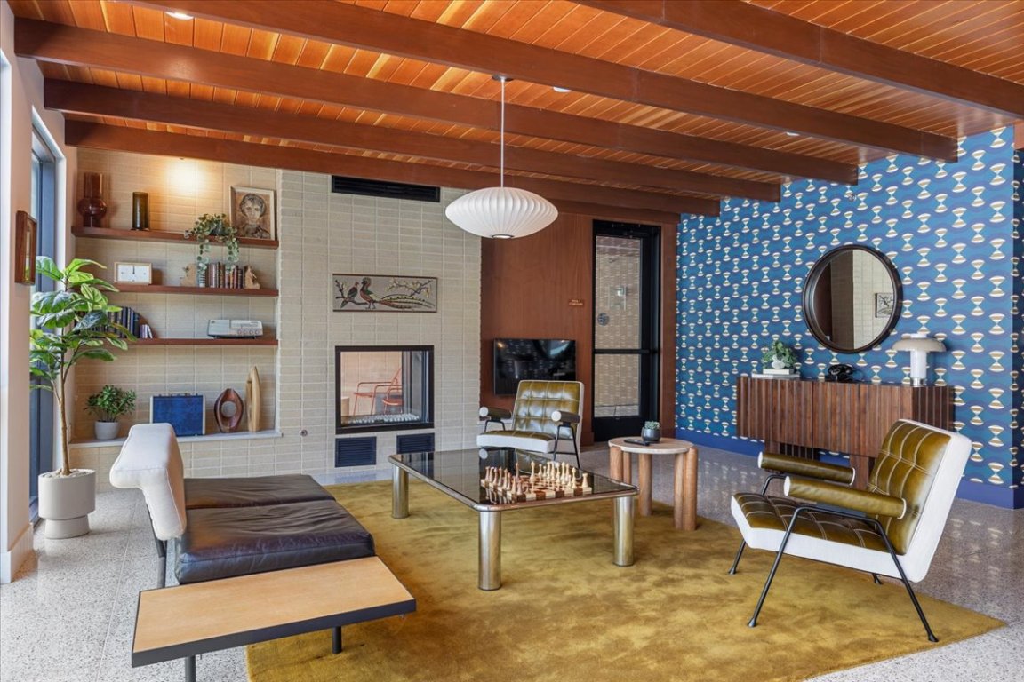 1701 Simond Avenue, Unit 636 Austin, TX 78723 - Photo 23 of 34 a living room with furniture a rug and a fireplace