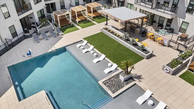 a view of a building with patio furniture and a fountain