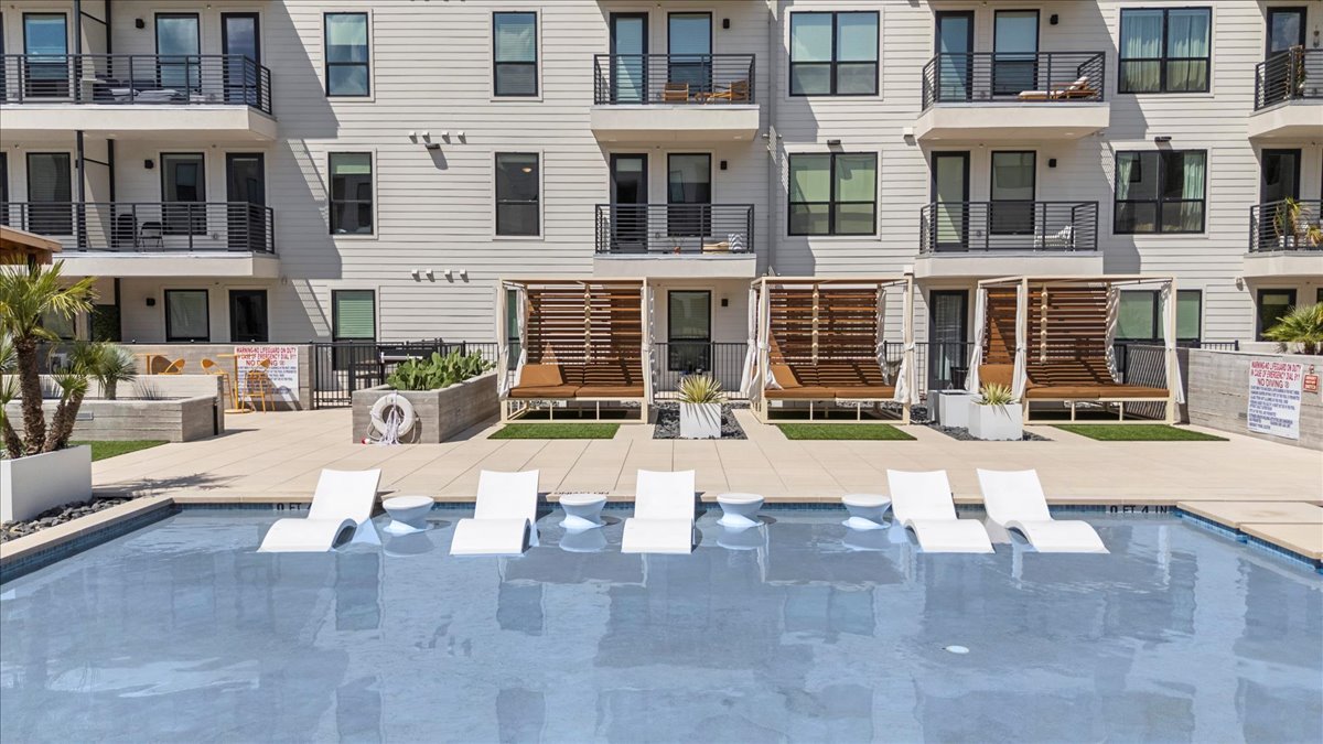 1701 Simond Avenue, Unit 636 Austin, TX 78723 - Photo 30 of 34 a view of a building with patio furniture and a fountain