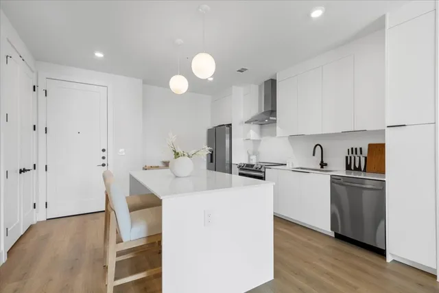 a kitchen with cabinets a sink and appliances
