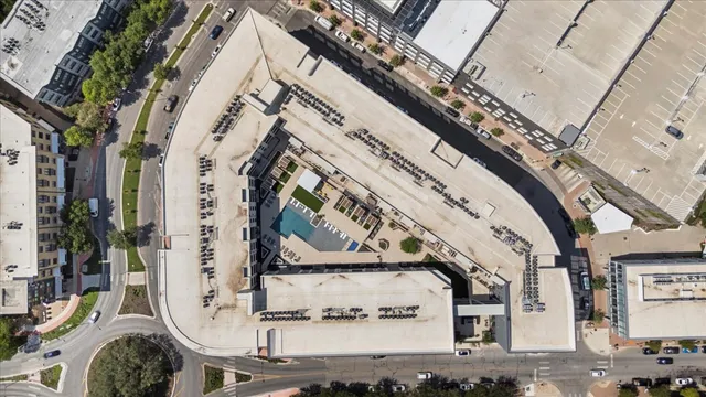 a view of a swimming pool with a table and chairs under an umbrella