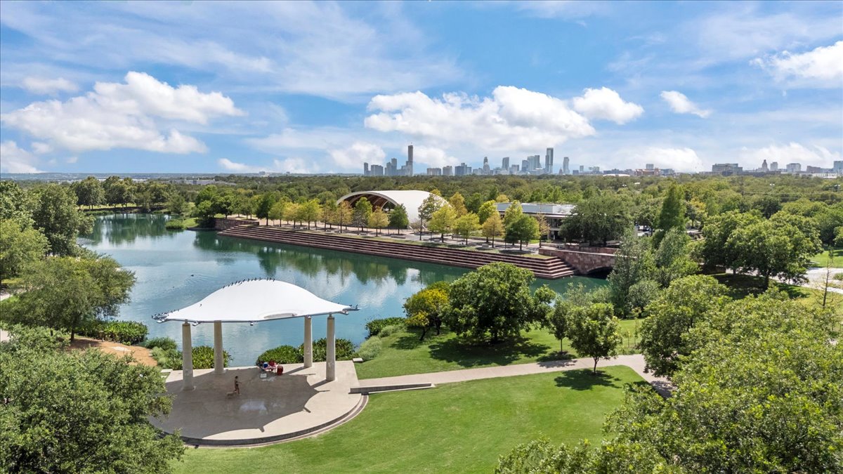 1701 Simond Avenue, Unit 636 Austin, TX 78723 - Photo 34 of 34 a view of a swimming pool with a table and chairs under an umbrella