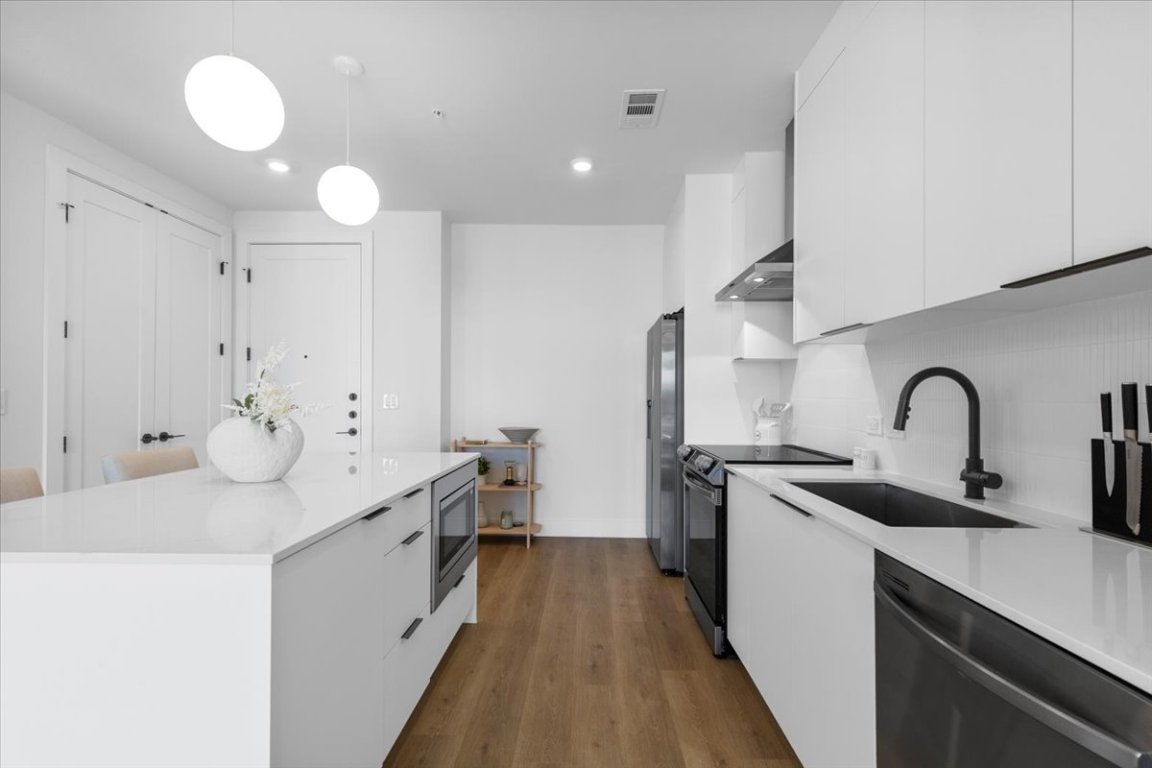 1701 Simond Avenue, Unit 636 Austin, TX 78723 - Photo 5 of 34 a kitchen with sink a stove and cabinets