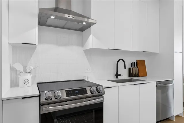 a kitchen with a stove and a white cabinet