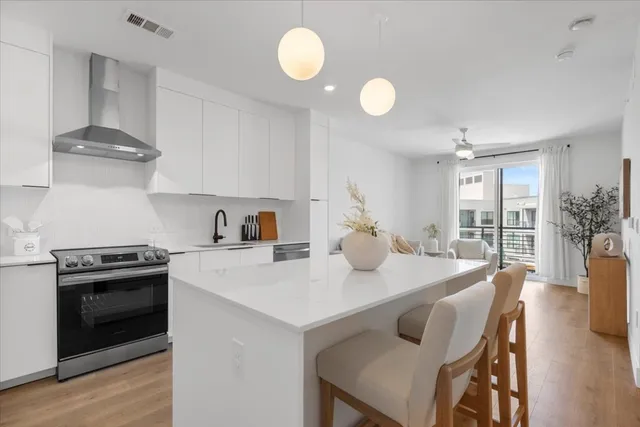 a kitchen with a stove a sink and a refrigerator