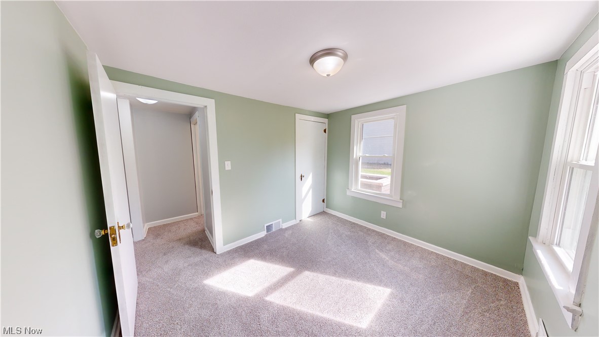 852 East Waterloo Road Akron, OH 44306 - Photo 18 of 24 Unfurnished bedroom featuring light colored carpet and a closet
