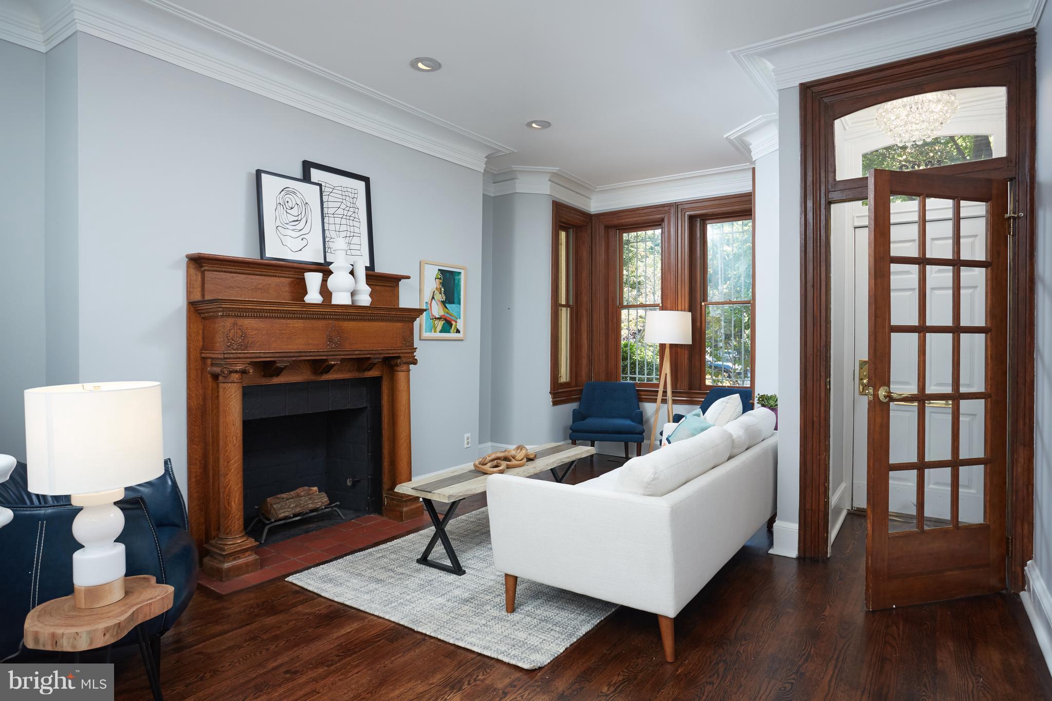 1822 16th Street Northwest Washington, DC 20009 - Photo 2 of 29 a living room with furniture and a fireplace