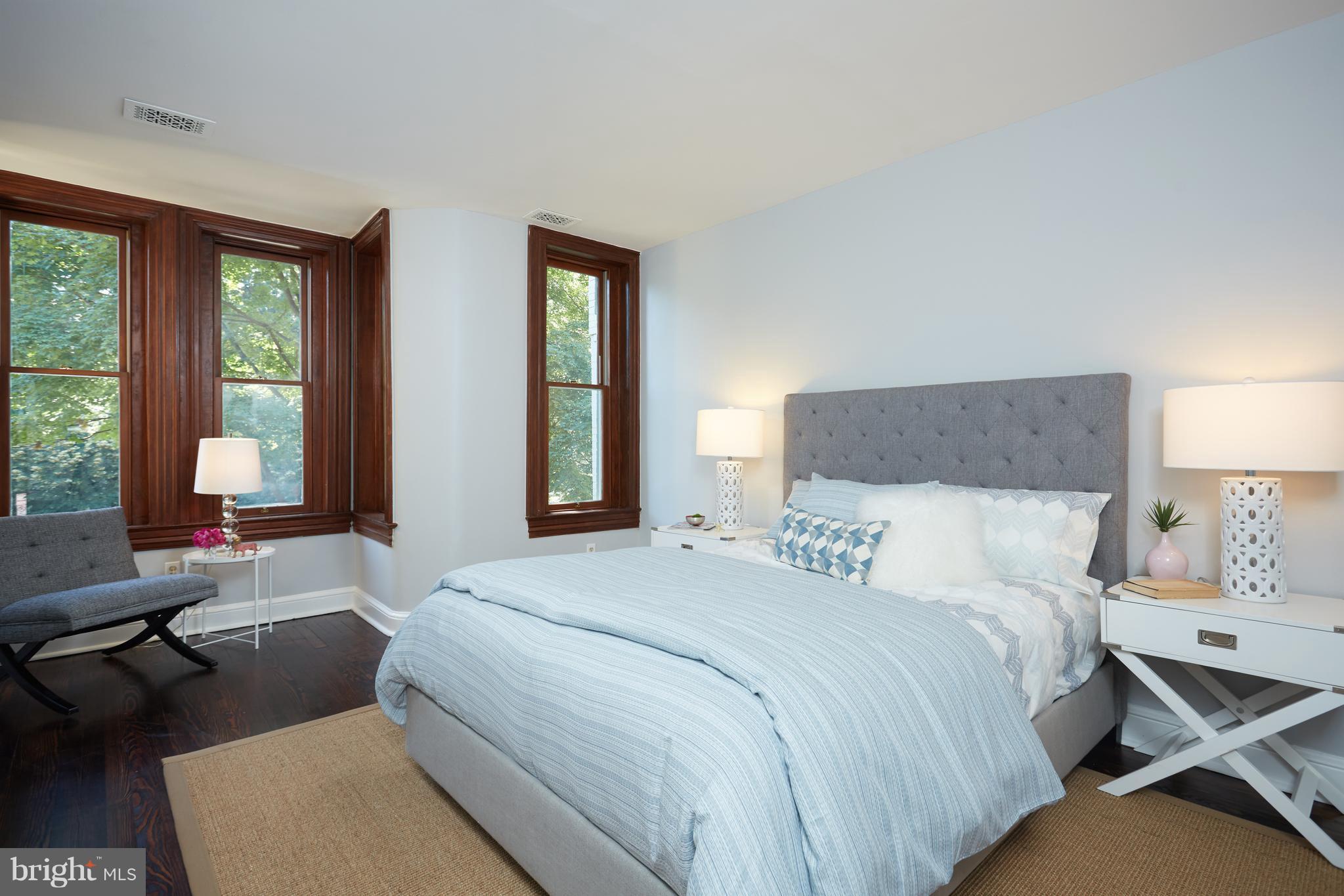 1822 16th Street Northwest Washington, DC 20009 - Photo 11 of 29 a bedroom with a bed and large windows