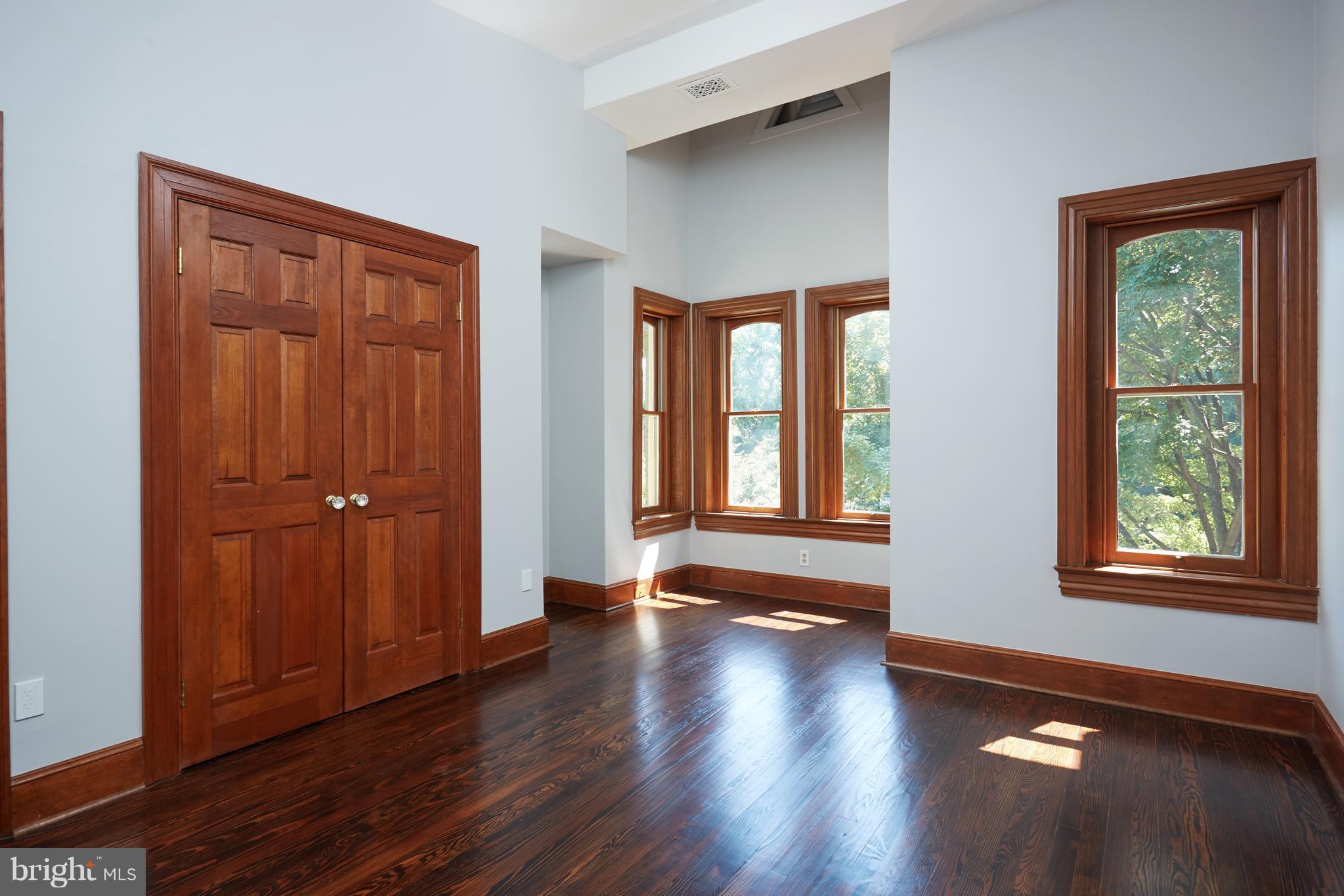 1822 16th Street Northwest Washington, DC 20009 - Photo 16 of 29 an empty room with wooden floor and windows