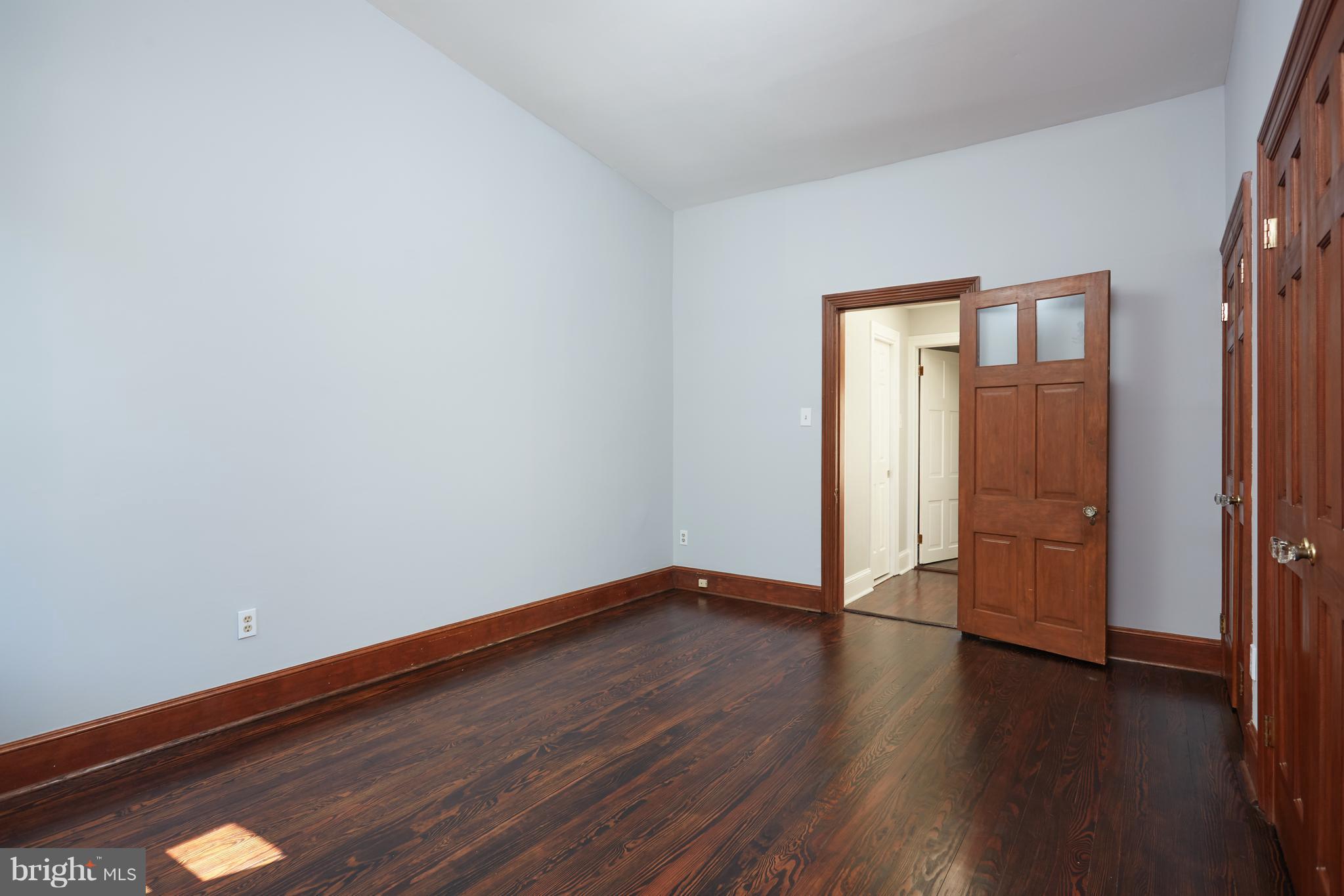 1822 16th Street Northwest Washington, DC 20009 - Photo 17 of 29 a view of an empty room with wooden floor and a window