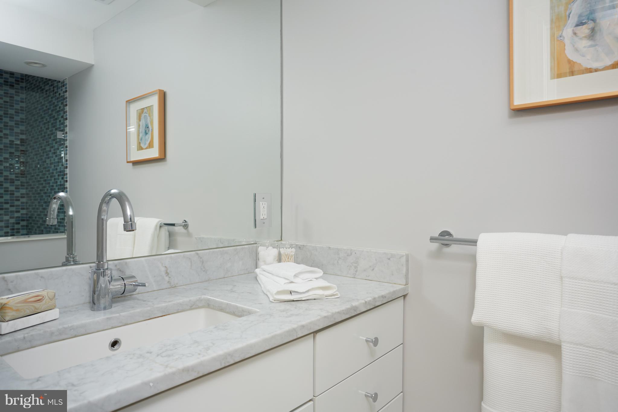 1822 16th Street Northwest Washington, DC 20009 - Photo 20 of 29 a bathroom with a granite countertop sink and a mirror