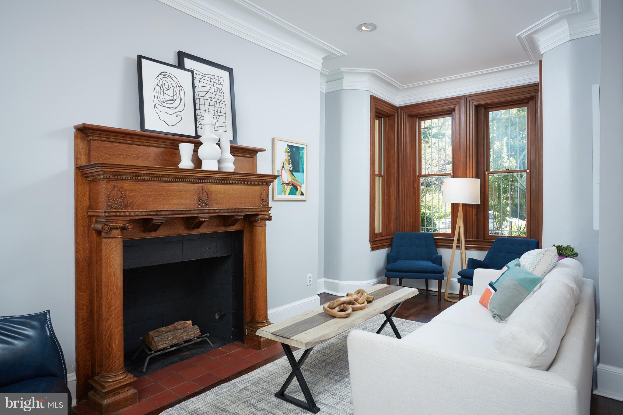 1822 16th Street Northwest Washington, DC 20009 - Photo 3 of 29 a living room with furniture and a fireplace