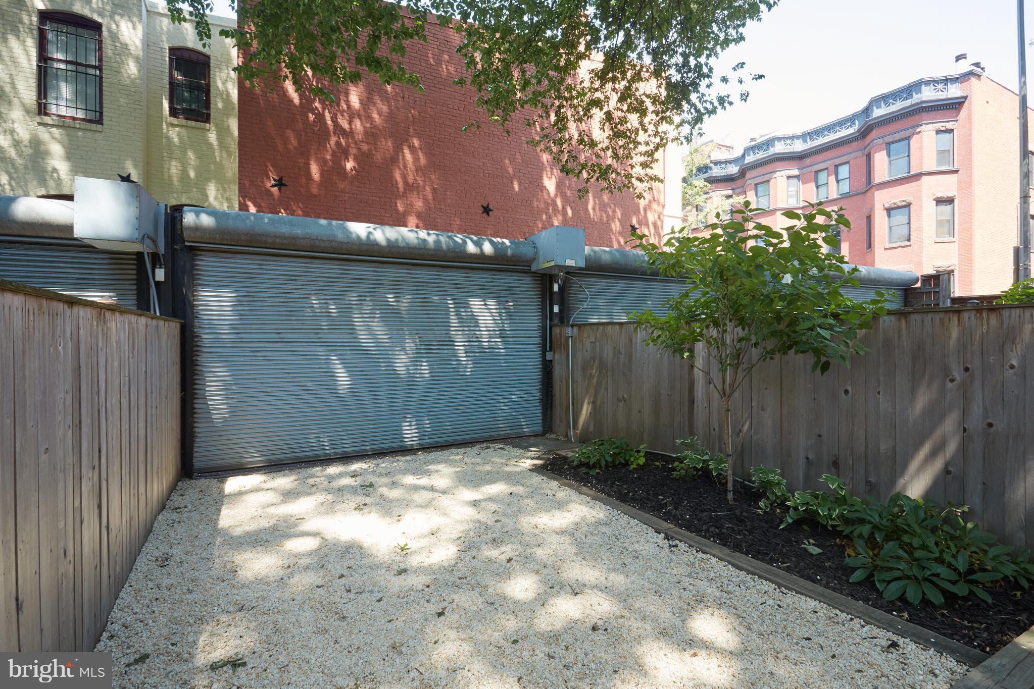 1822 16th Street Northwest Washington, DC 20009 - Photo 27 of 29 a view of backyard with potted plants and a large tree