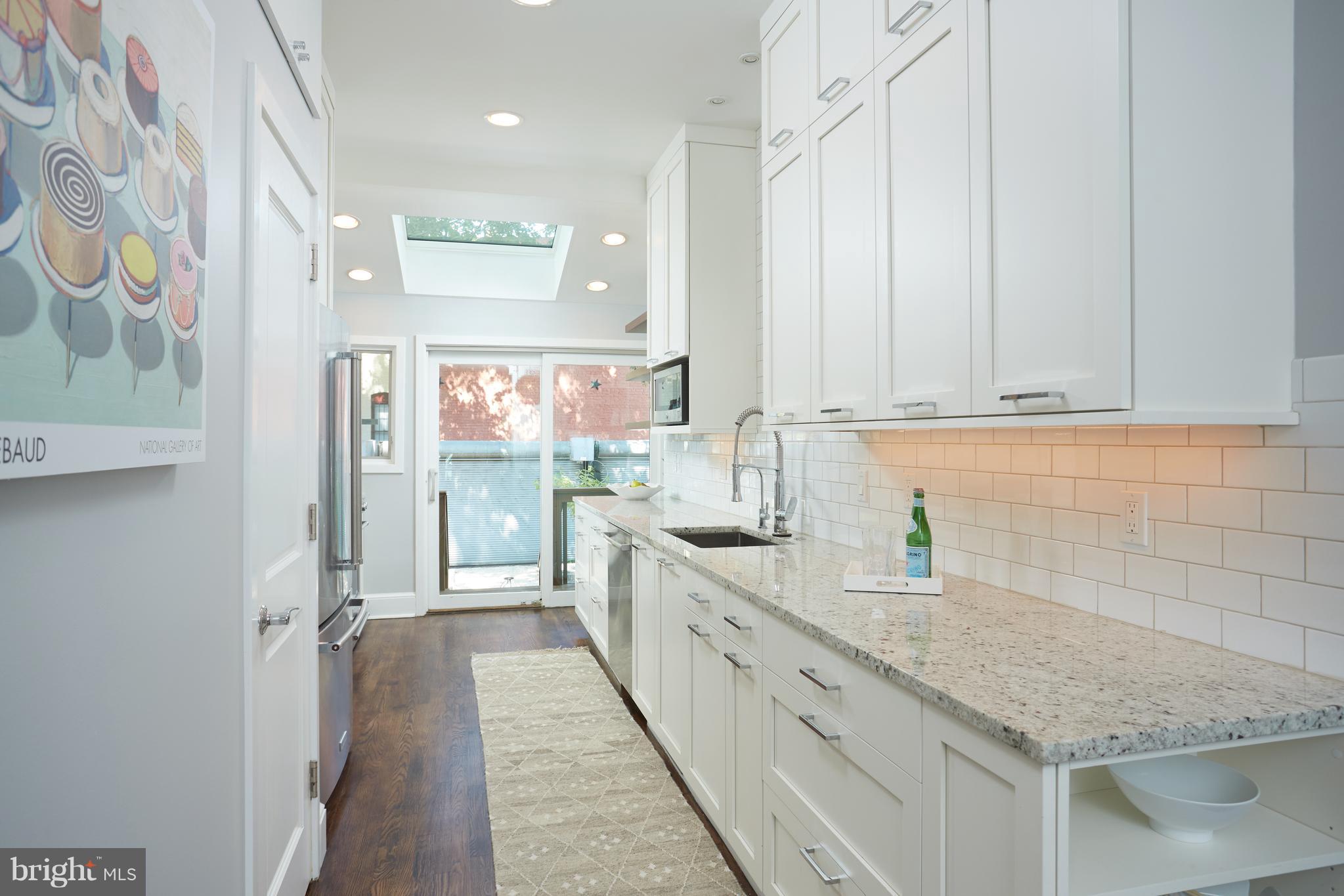 1822 16th Street Northwest Washington, DC 20009 - Photo 8 of 29 a bathroom with a granite countertop sink and a shower