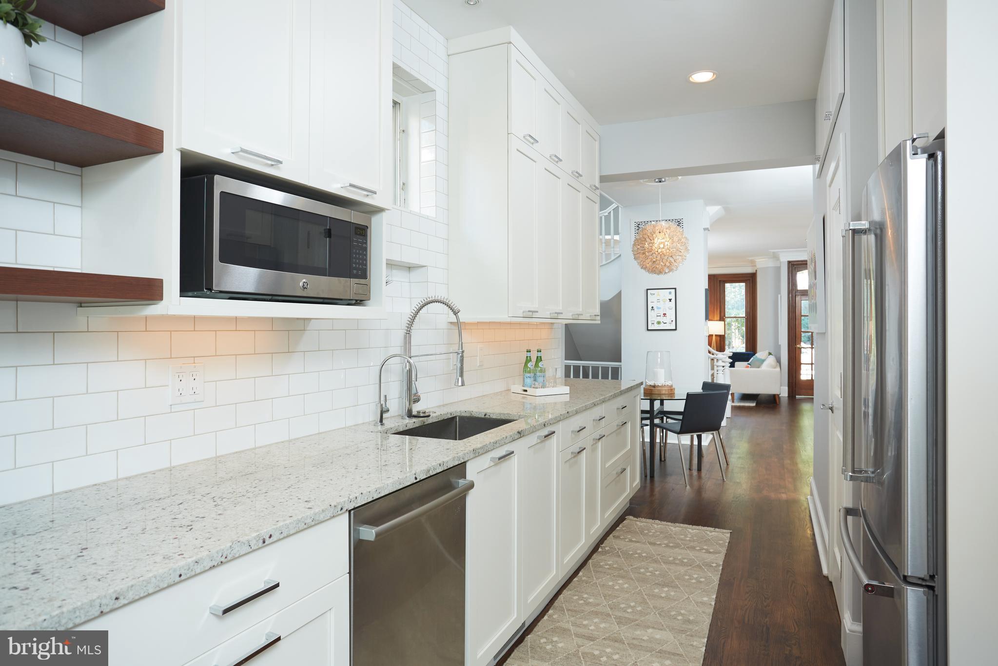 1822 16th Street Northwest Washington, DC 20009 - Photo 10 of 29 a kitchen with stainless steel appliances granite countertop a sink and stove