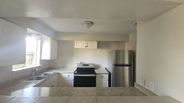 a kitchen with a refrigerator and a sink