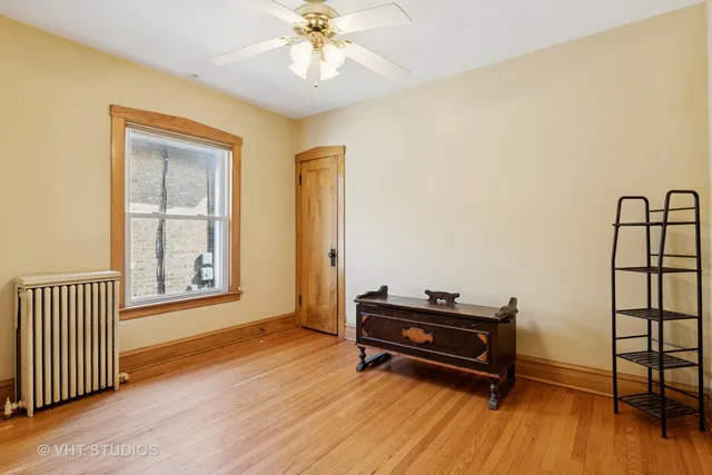 a view of room with wooden floor and a piano