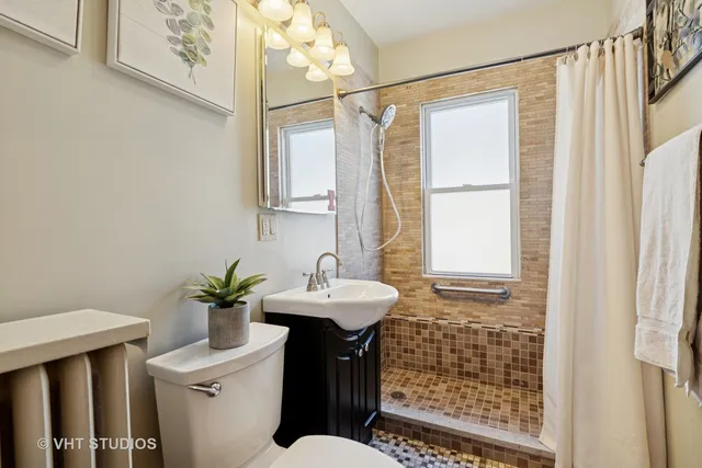 a bathroom with a sink toilet and shower