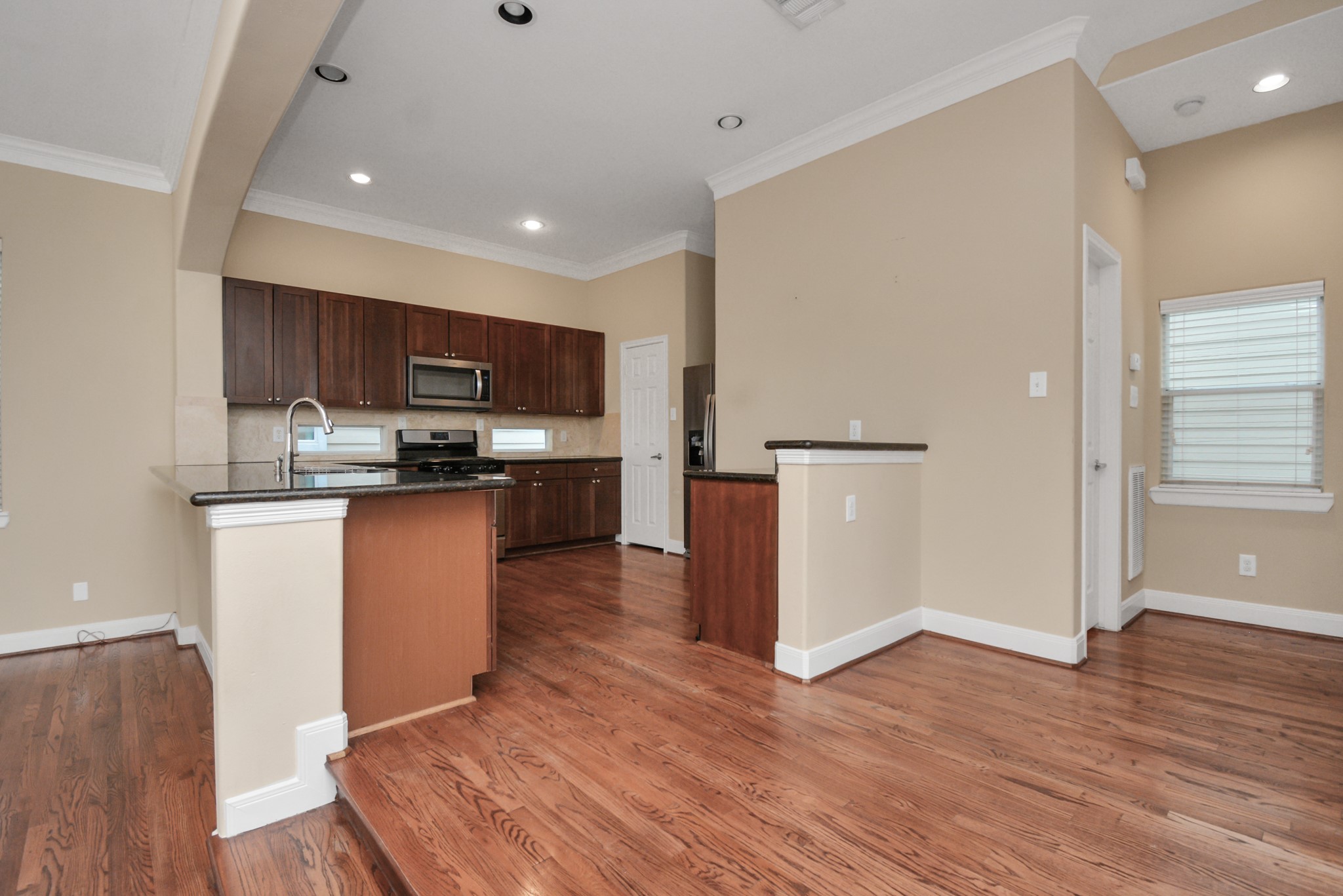 1137 West 24th Street, Unit A Houston, TX 77008 - Photo 15 of 40 a kitchen with stainless steel appliances granite countertop a refrigerator stove a sink and a microwave