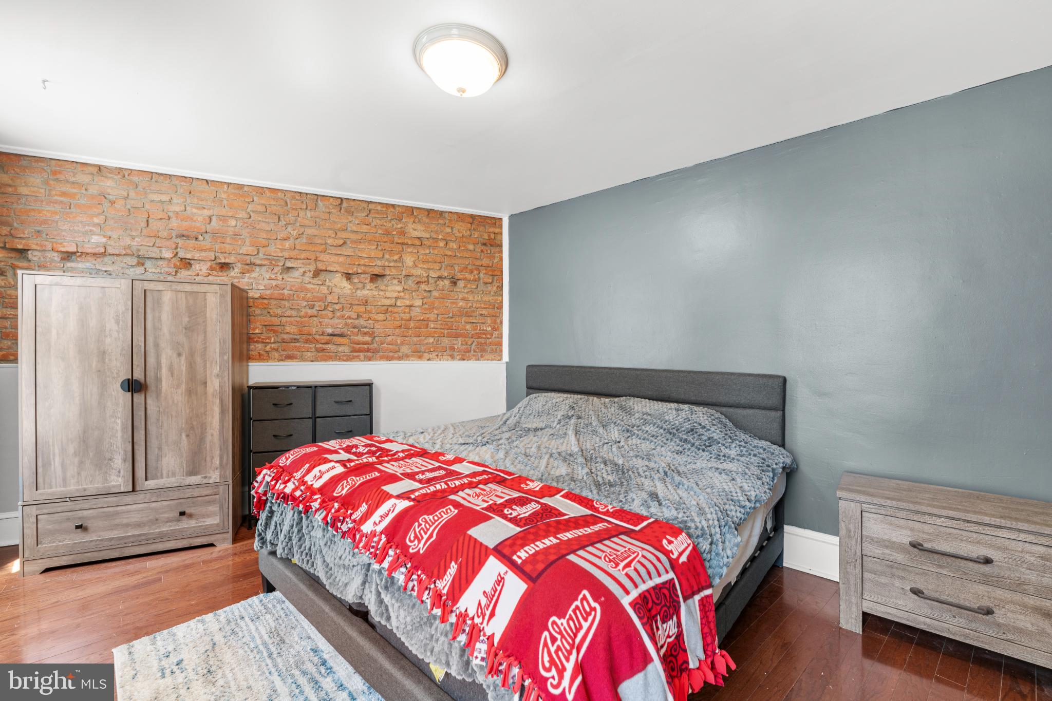2501 East Norris Street Philadelphia, PA 19125 - Photo 15 of 25 Charming bedroom with exposed brick accents.
