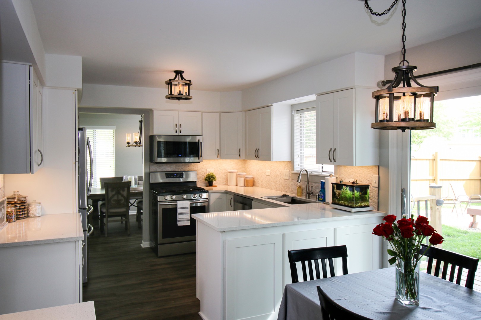 574 Foxford Road Bartlett, IL 60103 - Photo 6 of 22 a kitchen with stainless steel appliances granite countertop a stove top oven a sink a dining table and chairs