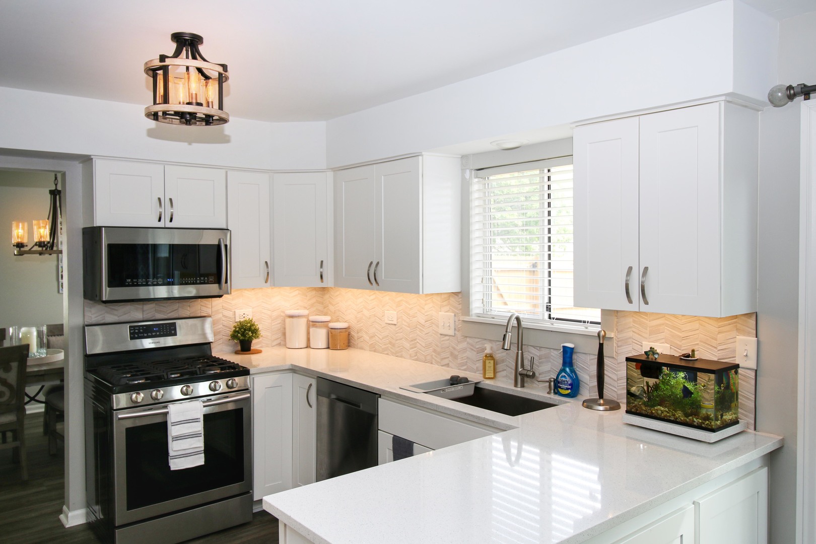 574 Foxford Road Bartlett, IL 60103 - Photo 7 of 22 a kitchen with stainless steel appliances a stove microwave and sink