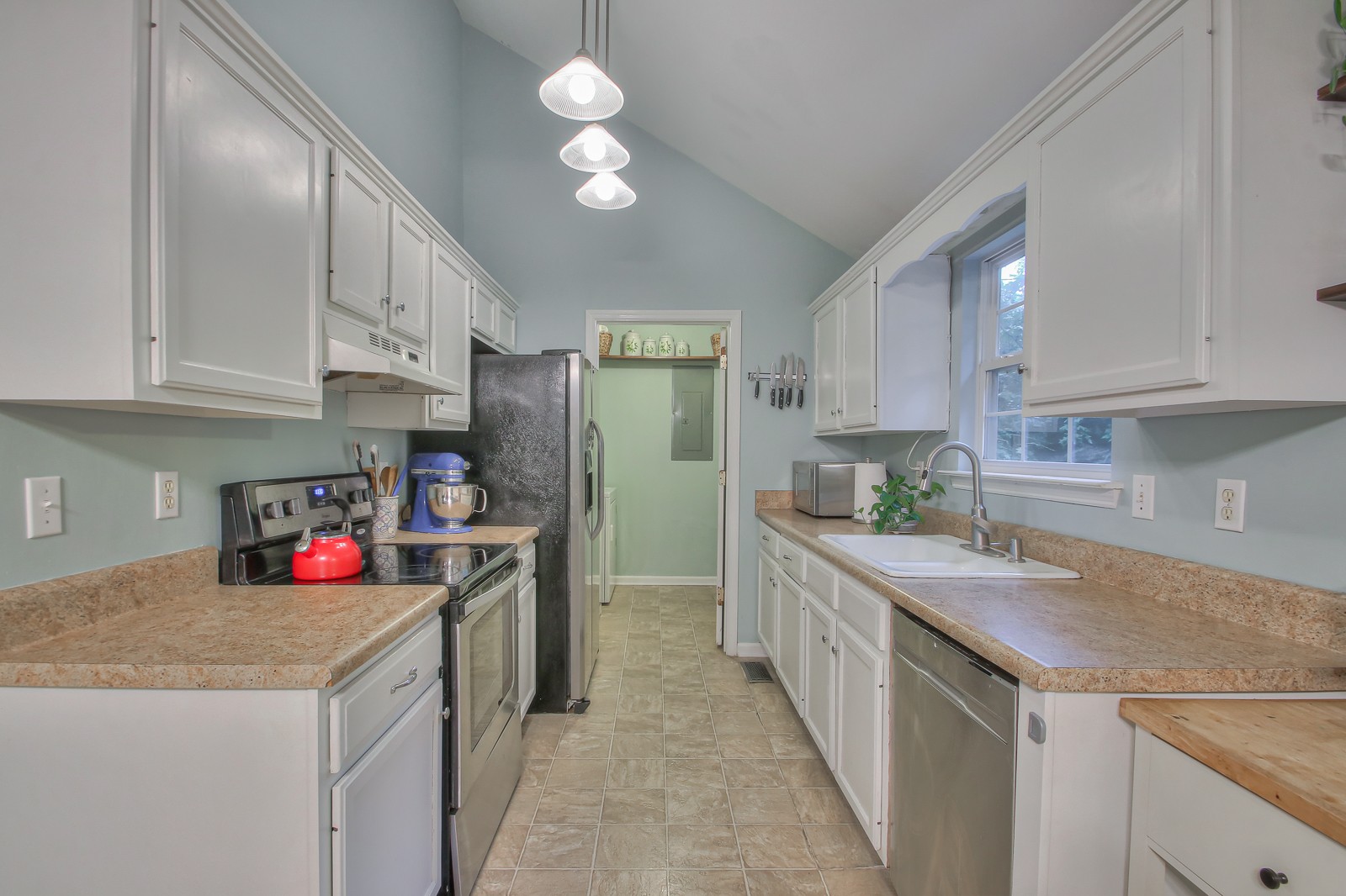 7481 Christopher Street Fairview, TN 37062 - Photo 30 of 42 a kitchen with a sink dishwasher stove and white cabinets